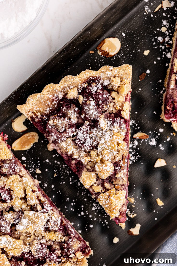 Overhead view of raspberry crumb tart slices on platter