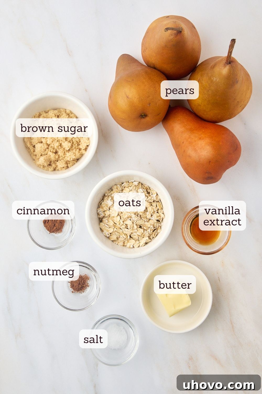 An overhead view showcasing all the fresh, simple ingredients neatly laid out on a surface, ready to be transformed into delicious baked pears.