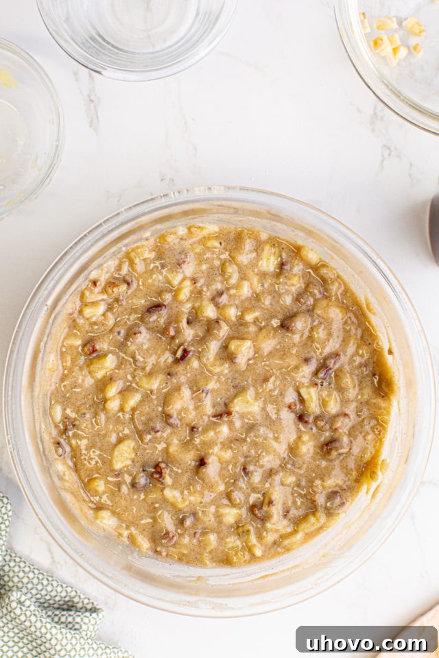 Overhead view of the completed Hummingbird Cupcake batter, rich with visible pineapple, banana, and pecans.