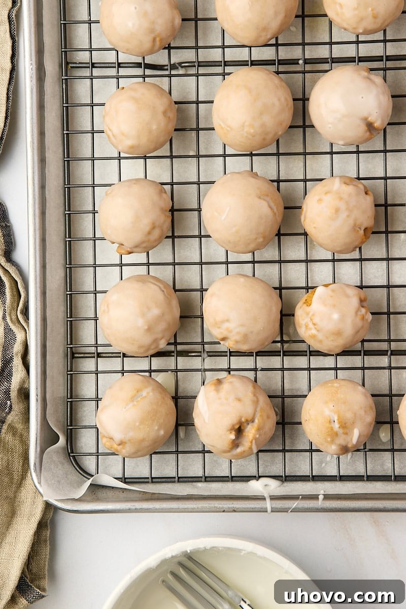 overhead view of glazed Pfeffernüsse cookies on a wire rack