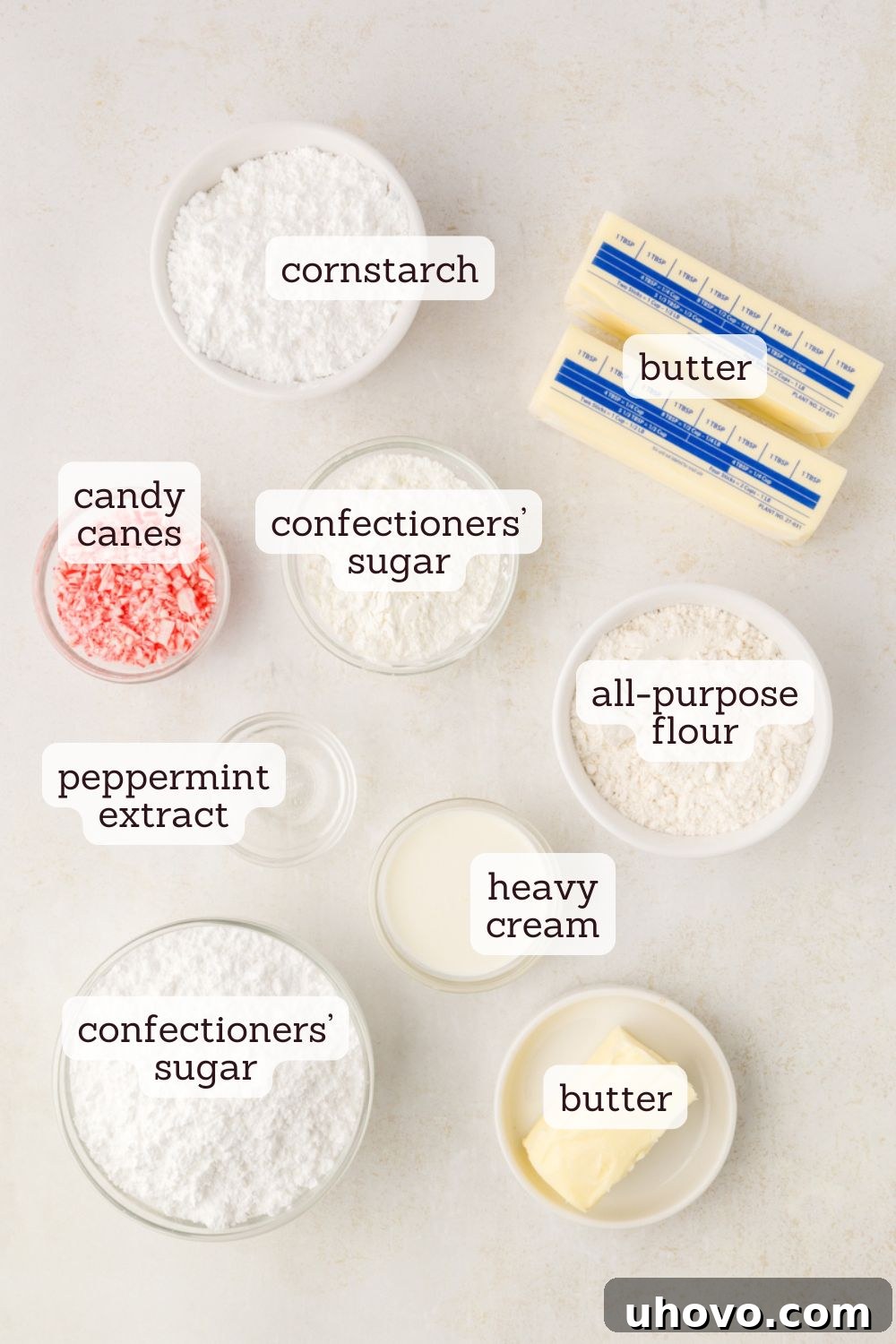 Overhead view of various ingredients laid out for making peppermint meltaways, including butter, sugar, flour, and peppermint extract.