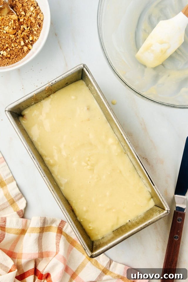 overhead view of remaining cinnamon swirl bread batter layered in a loaf pan