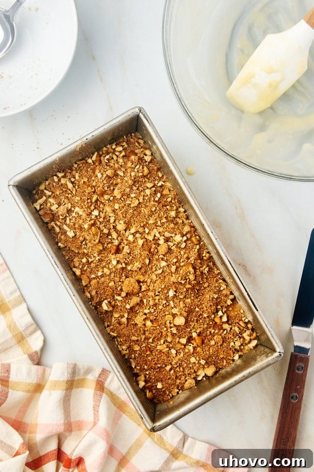 overhead view of remaining cinnamon swirl mixture added to quick bread batter in a loaf pan