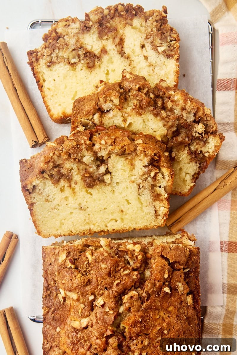overhead view of partially sliced cinnamon swirl bread on parchment paper