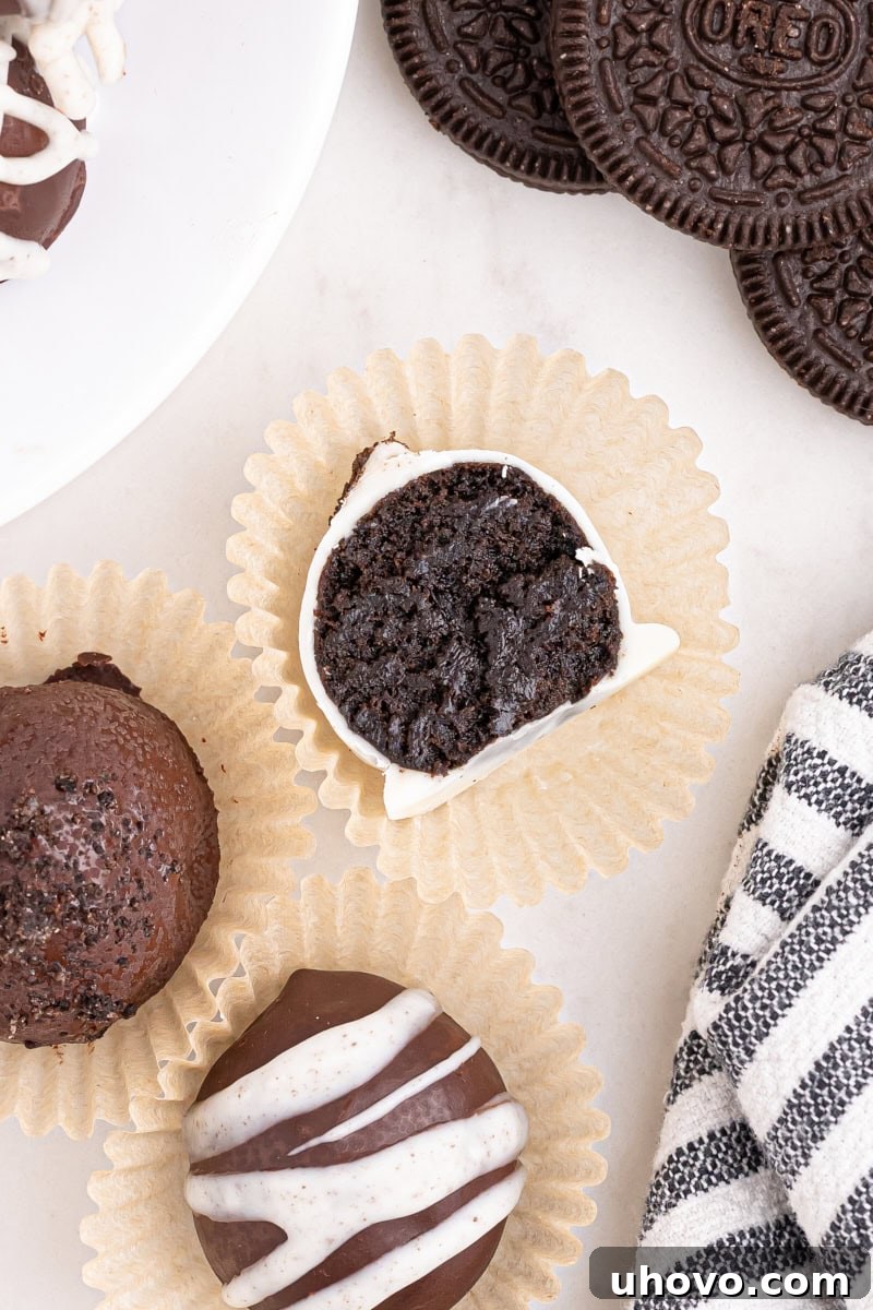Overhead view of an Oreo truffle cut in half, revealing the dense, creamy Oreo and cream cheese interior.