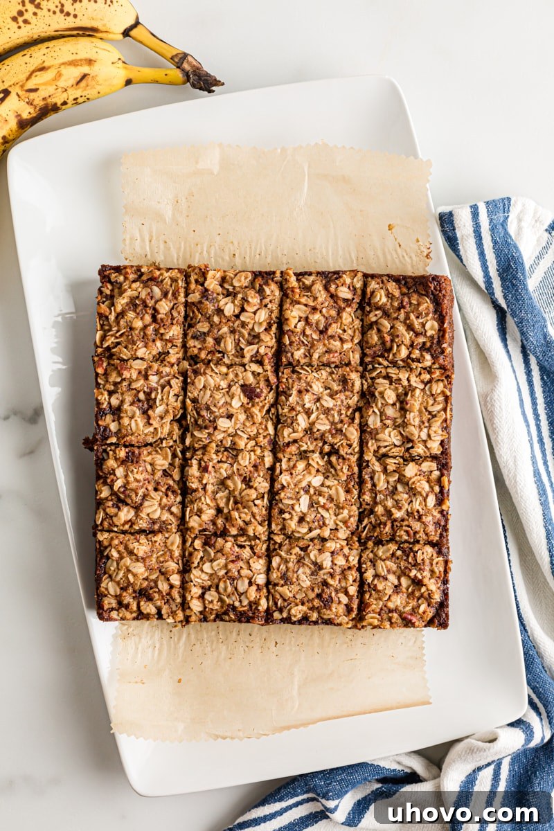 Overhead view of cut banana oatmeal crumb cake on platter