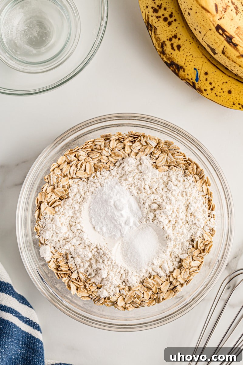 Overhead view of oats and dry ingredients in mixing bowl