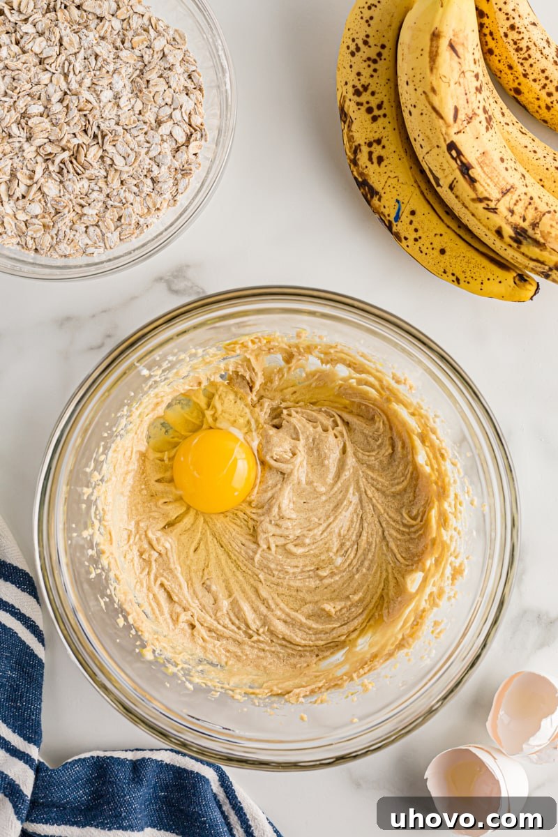 Overhead view of egg added to cake batter