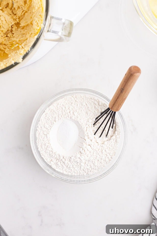 Overhead view of flour and salt in a mixing bowl, ready to be whisked together.