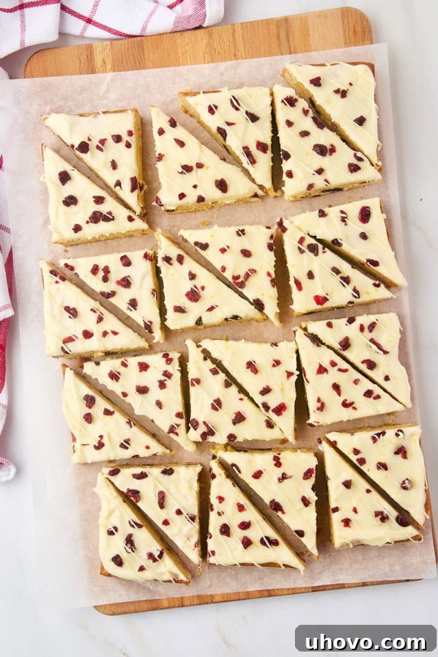 Overhead view of sliced cranberry bliss bars on parchment paper
