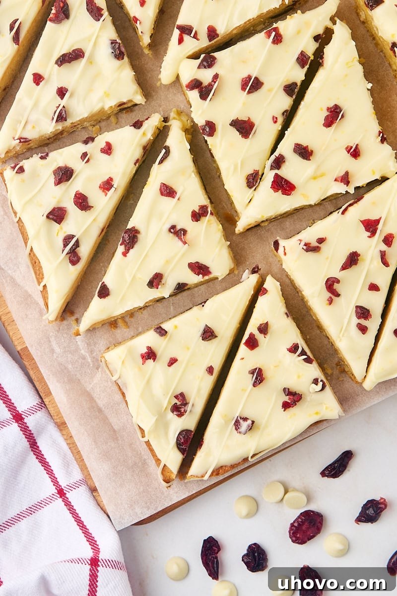 Overhead view of several cranberry bliss bars on a cutting board