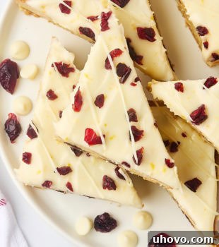 Overhead view of several cranberry bliss bars on a white plate