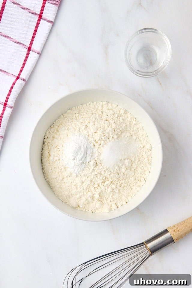 Overhead view of flour, baking powder, and salt in a bowl