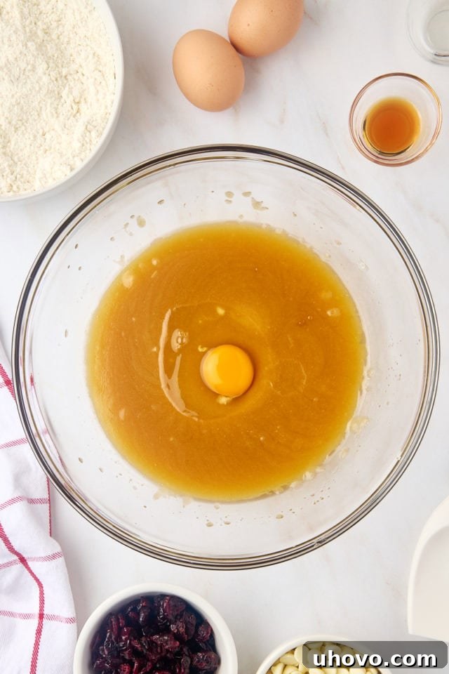 Overhead view of egg added to butter/sugar mixture