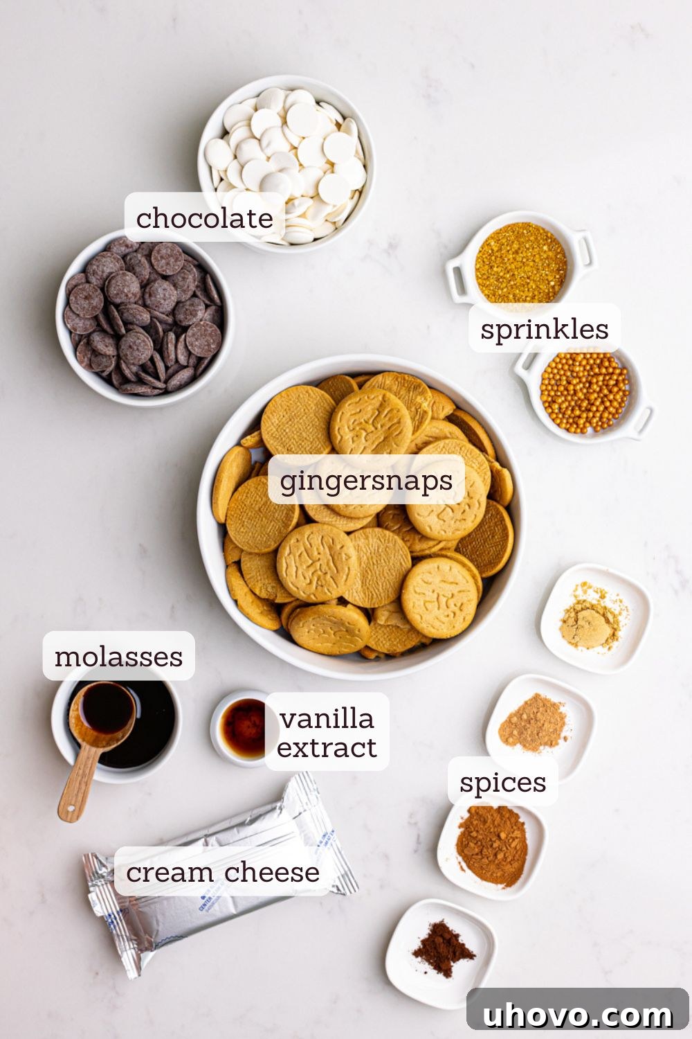 Overhead view of all the ingredients laid out for making gingerbread truffles, including gingersnap cookies, cream cheese, molasses, and various spices.