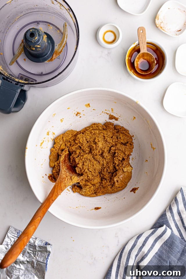 Overhead view of the mixed gingerbread truffles filling, showing a smooth, cohesive dough-like consistency in a mixing bowl.