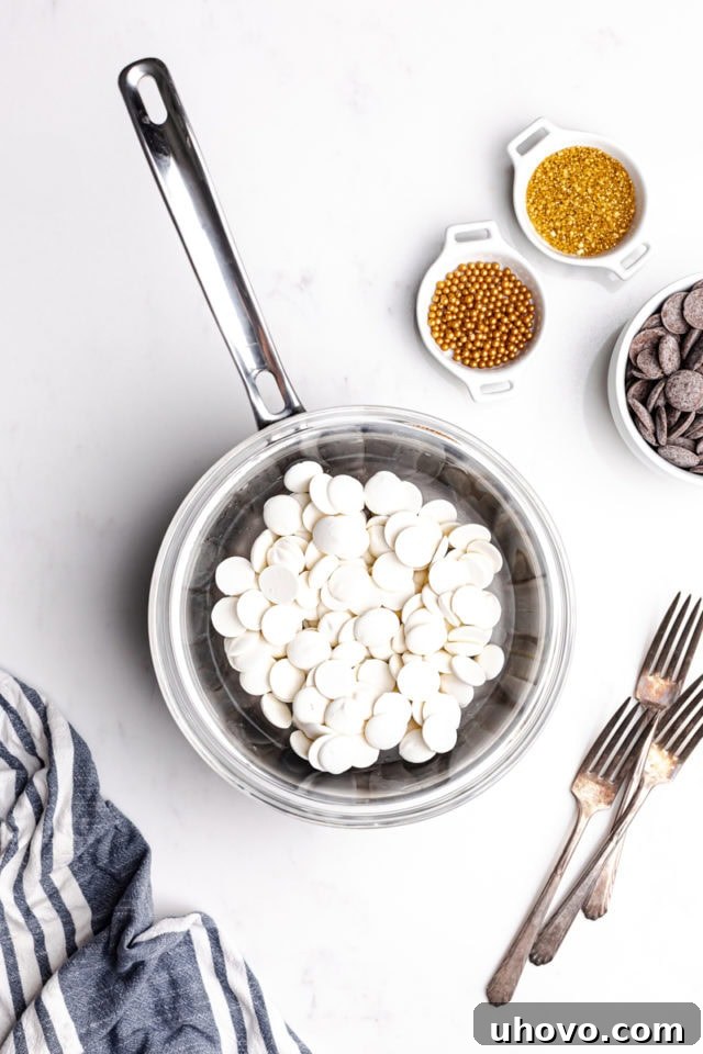 Overhead view of white chocolate melting gently in a double boiler, creating a smooth, glossy texture for dipping.