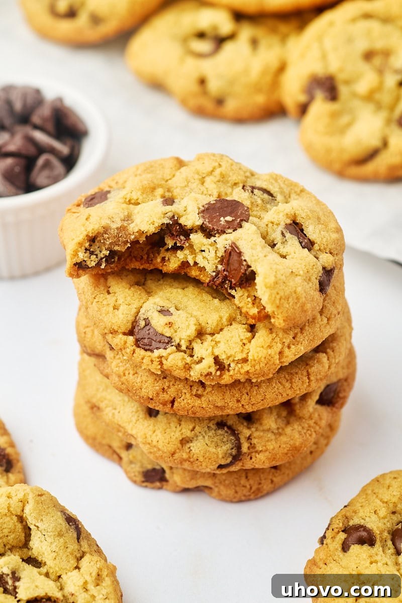 stack of four tahini chocolate chip cookies with a bite missing from the top cookie