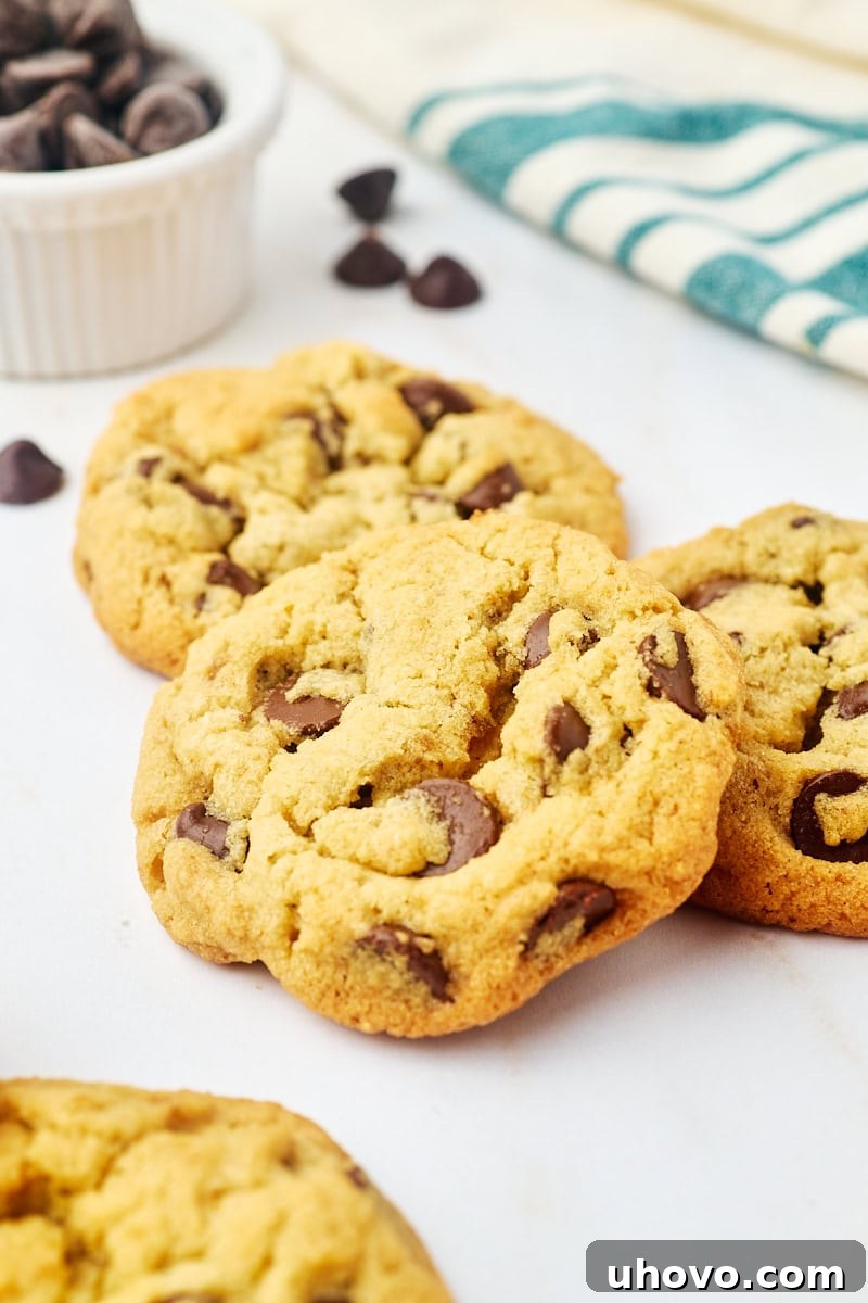 three tahini chocolate chip cookies on a marble countertop