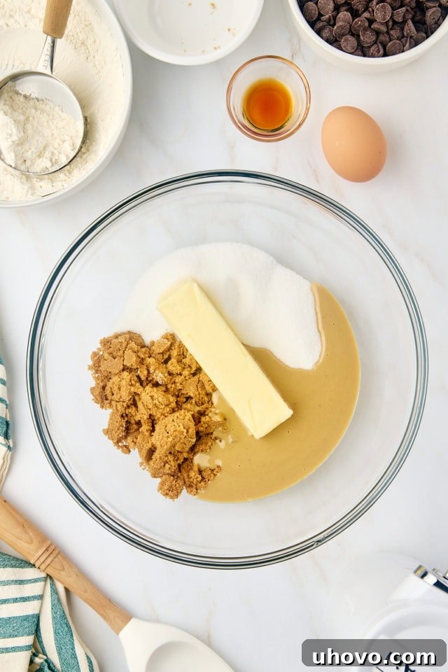 overhead view of butter, tahini, sugar, and brown sugar in a glass mixing bowl