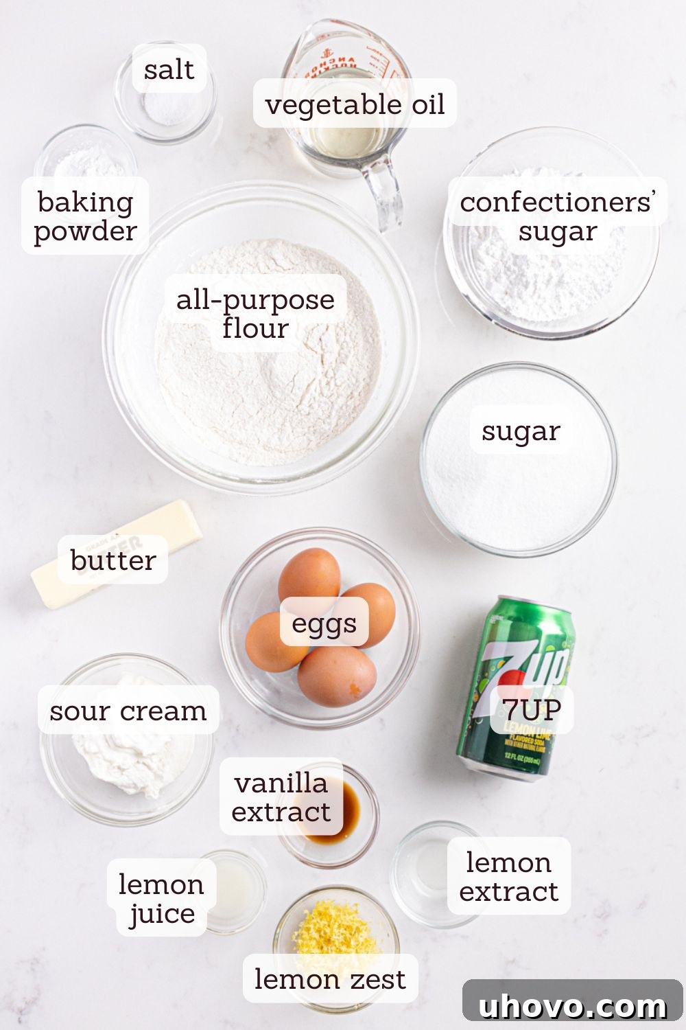 Overhead view of various ingredients for 7UP cake neatly arranged, including flour, sugar, butter, eggs, and a can of 7UP.