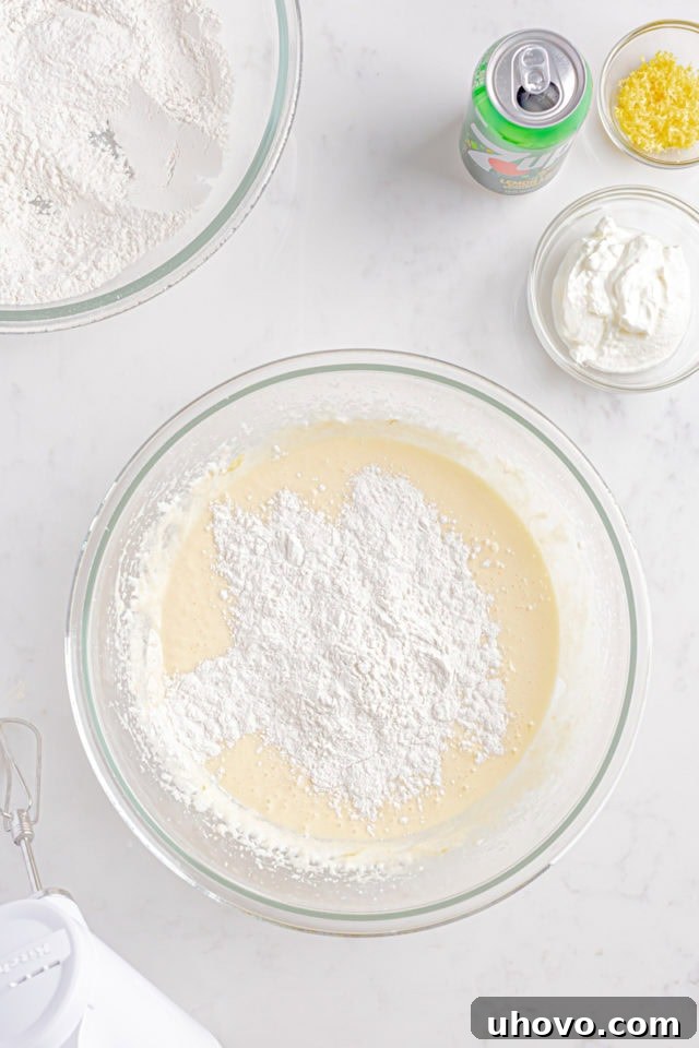 Overhead view of dry ingredients being gently folded into the wet ingredients for the 7UP cake batter.