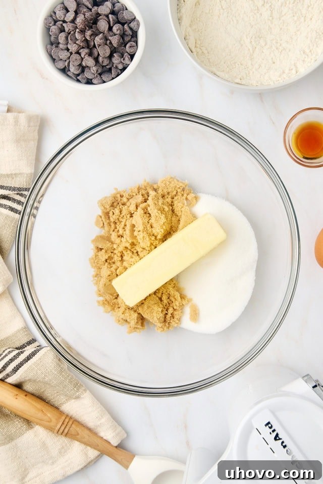 overhead view of butter, sugar, and brown sugar in a glass mixing bowl