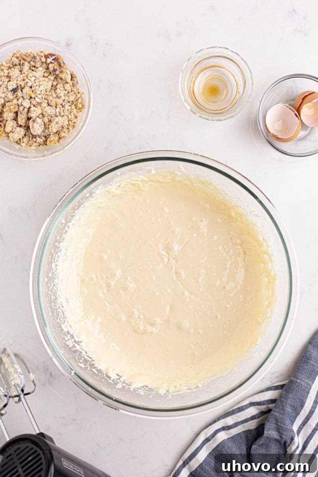 overhead view of mixed cheesecake filling for apple butter cream cheese oat bars