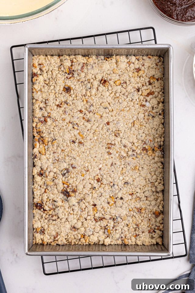 overhead view of partially baked oat crust for apple butter cream cheese oat bars
