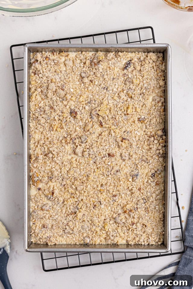 overhead view of assembled apple butter cream cheese oat bars ready to go into the oven