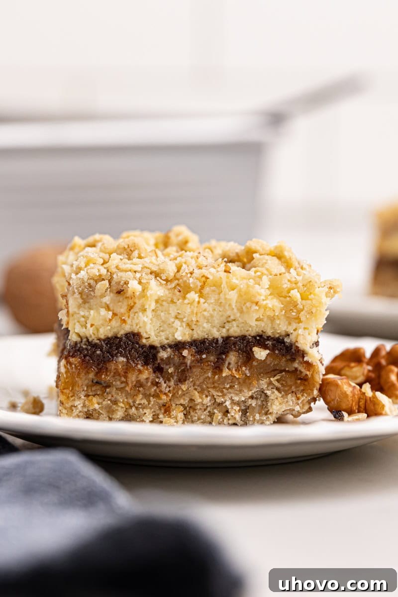 an apple butter cream cheese oat bar on a white plate