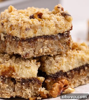 three apple butter cream cheese oat bars on a white plate