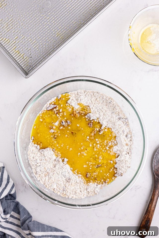 overhead view of melted butter added to oat crust mixture