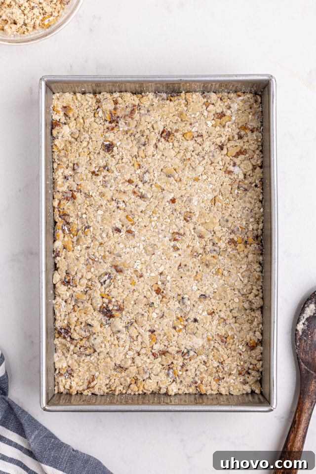 overhead view of oat crust mixture pressed into a 9x13 pan