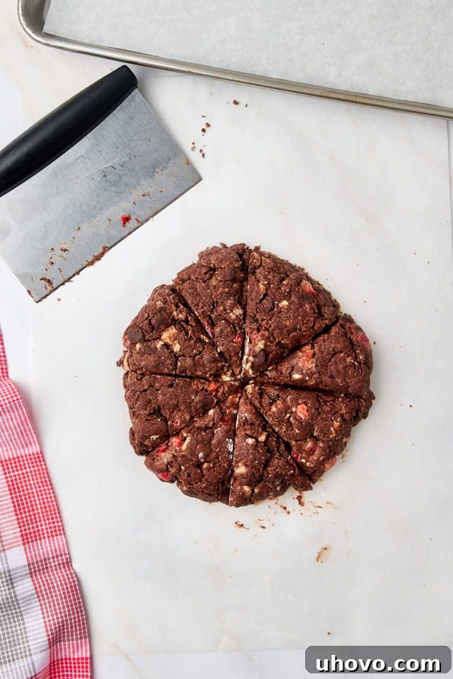 Overhead view of the scone dough disc cut into eight uniform wedges with a sharp knife.