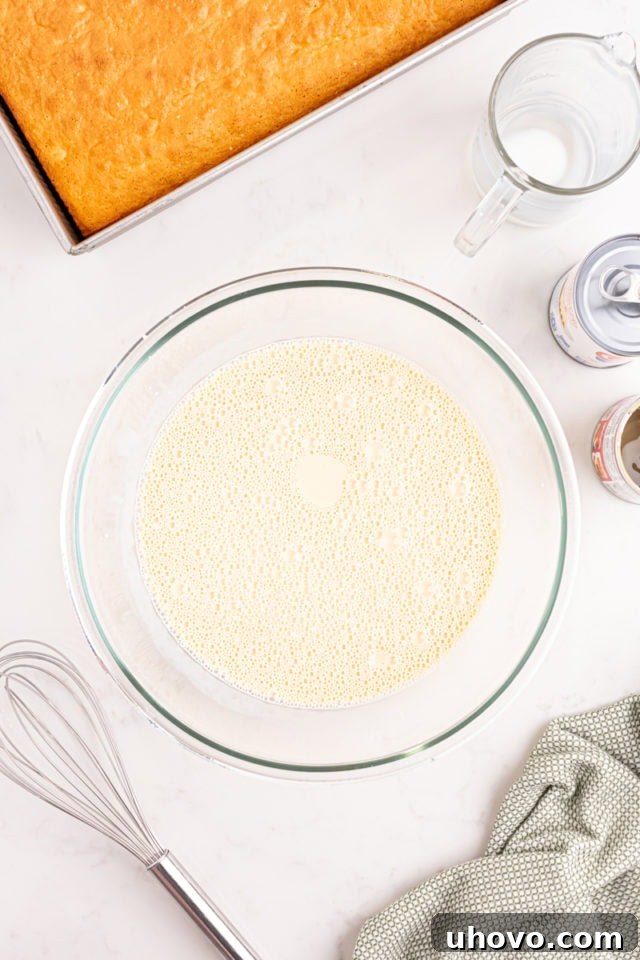 Overhead view of the three-milk mixture, a creamy blend of evaporated milk, sweetened condensed milk, and whole milk, ready to soak the cake.