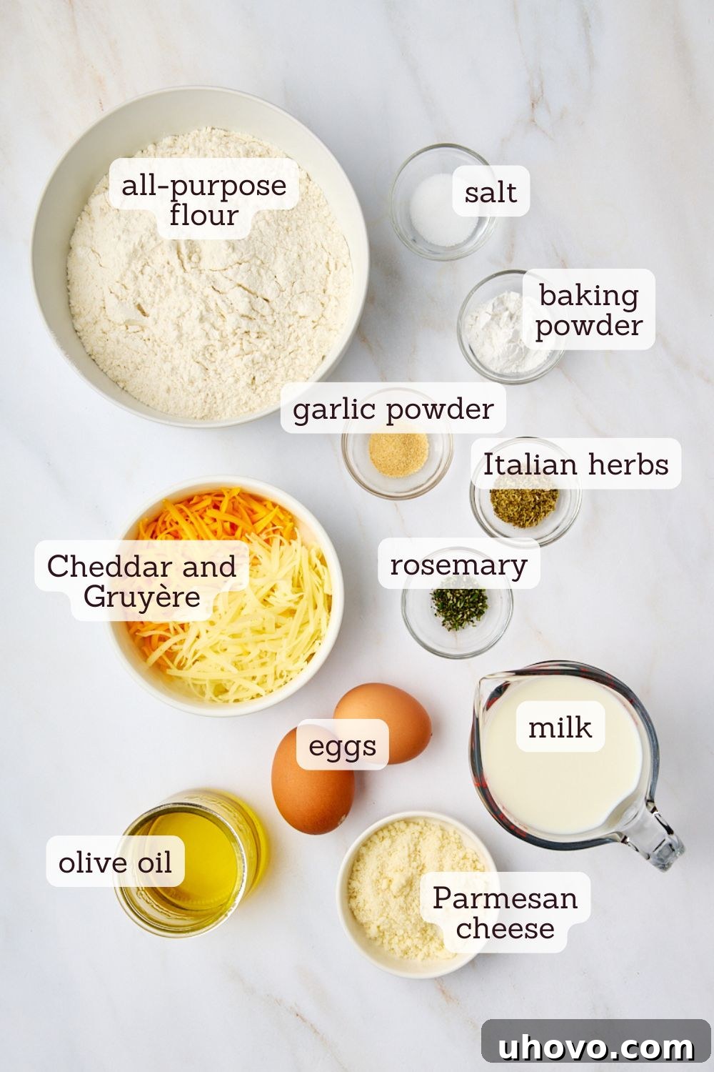 overhead view of ingredients for herb and cheese quick bread laid out on a wooden surface