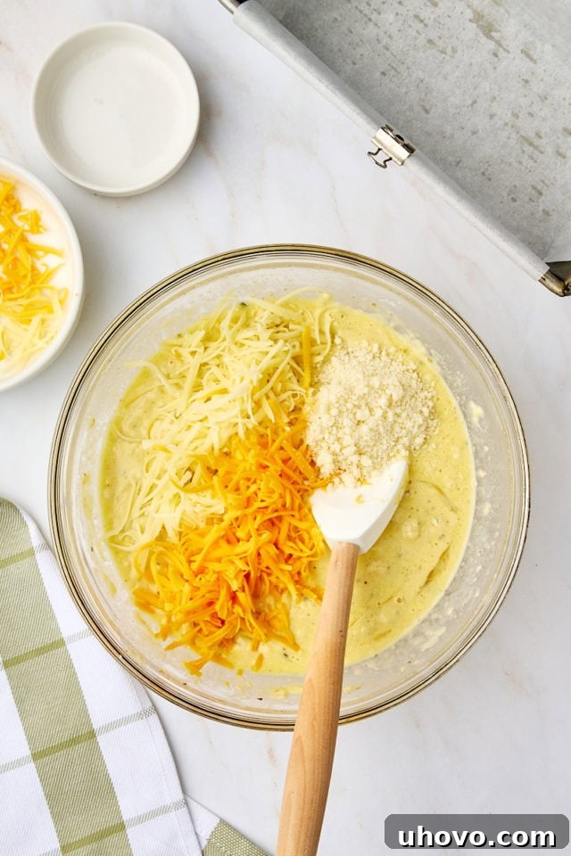 overhead view of cheeses added to herbed quick bread batter
