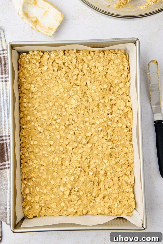 overhead view of the base layer of revel bars spread in a 9x13 pan