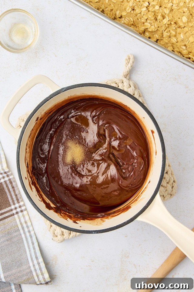 overhead view of vanilla and salt added to chocolate mixture for revel bars