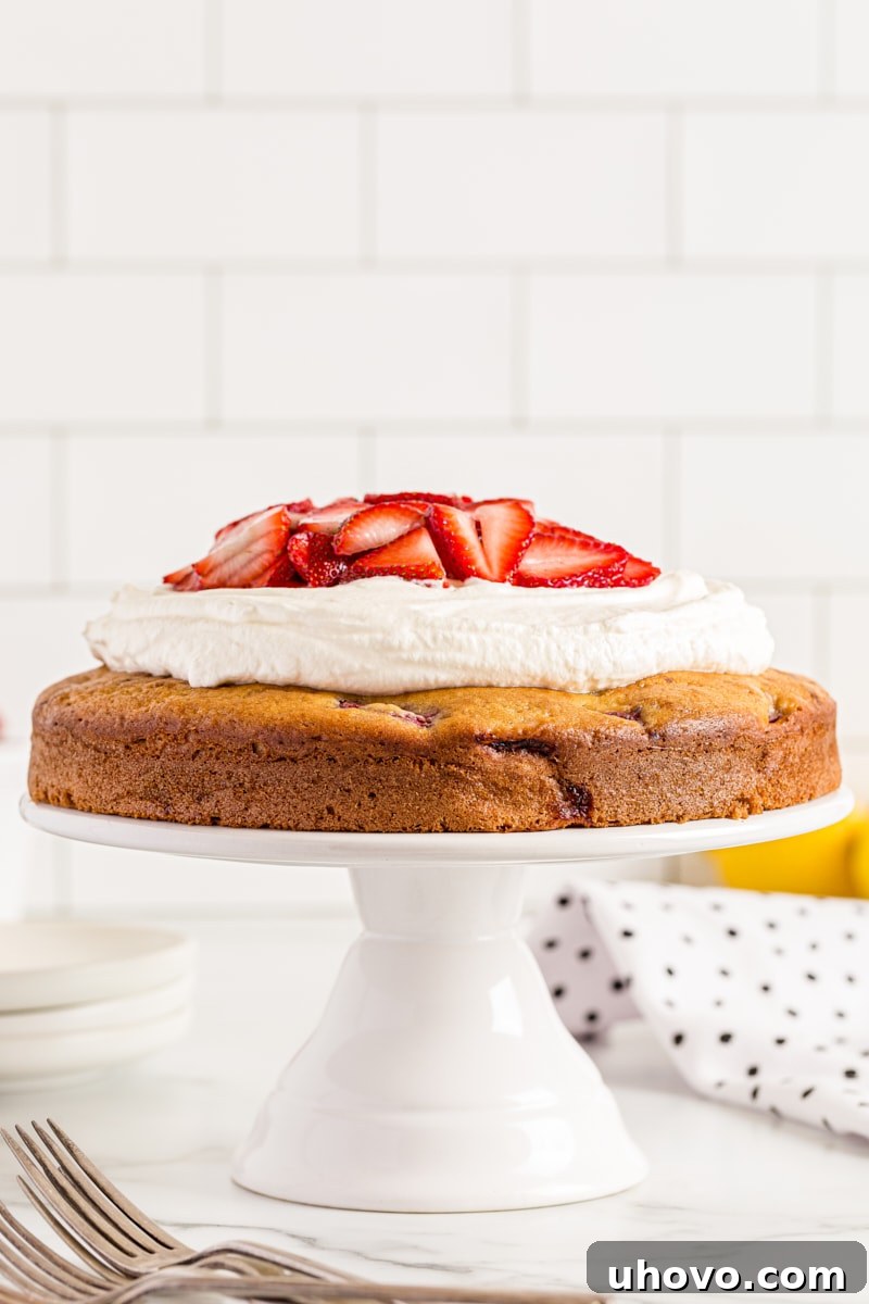 Lemon-Strawberry Shortcake Cake presented beautifully on a cake stand, ready for a spring celebration.