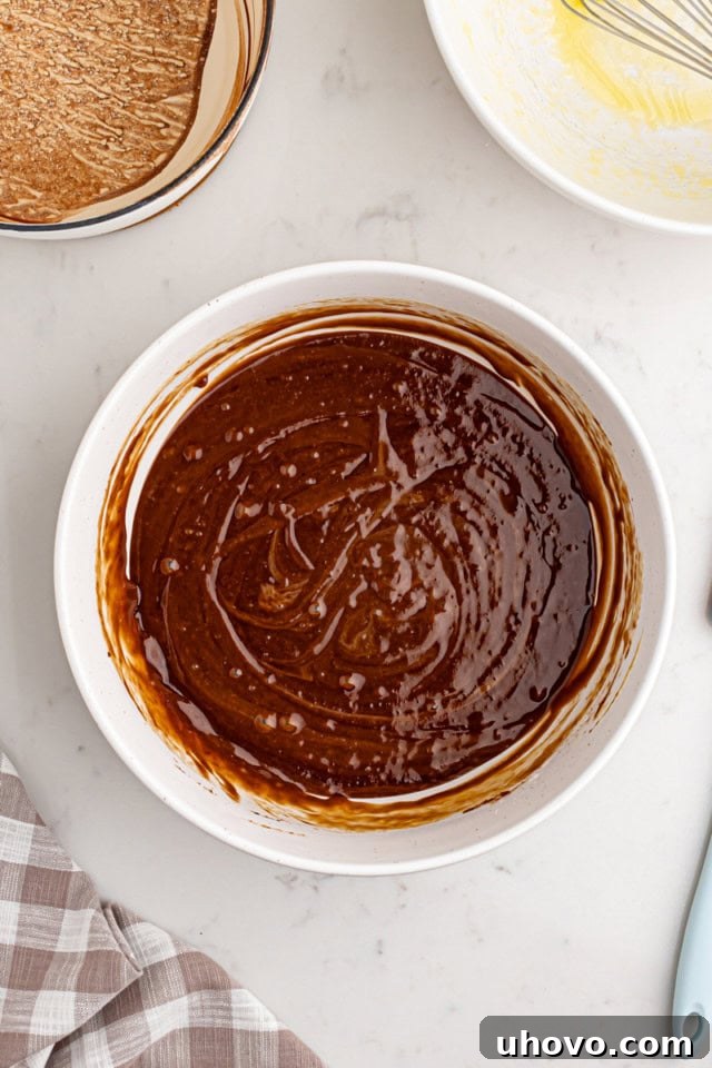 Smooth, fully combined Texas sheet cake batter in a large white mixing bowl, ready for baking.