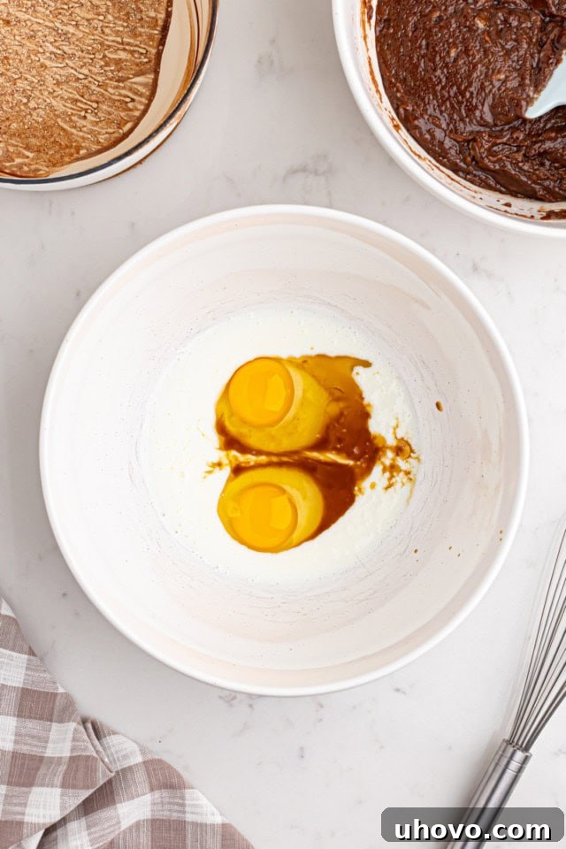 Small bowl containing whisked eggs, buttermilk, and vanilla extract, ready to be added to the cake batter.