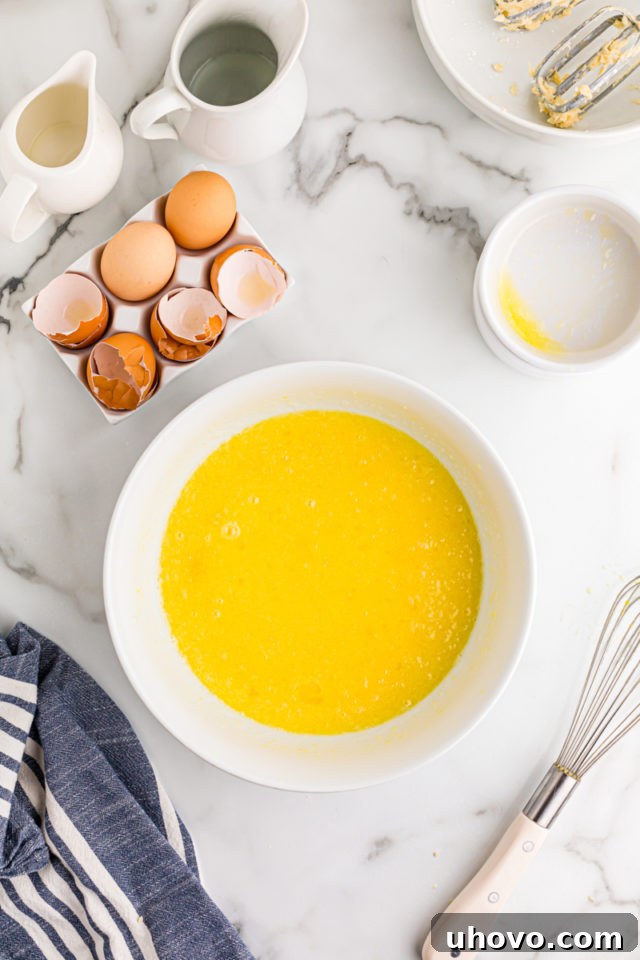 The smoothly whisked filling for Lemon Chess Tartlets, a vibrant yellow mixture, ready to be poured into the crusts.