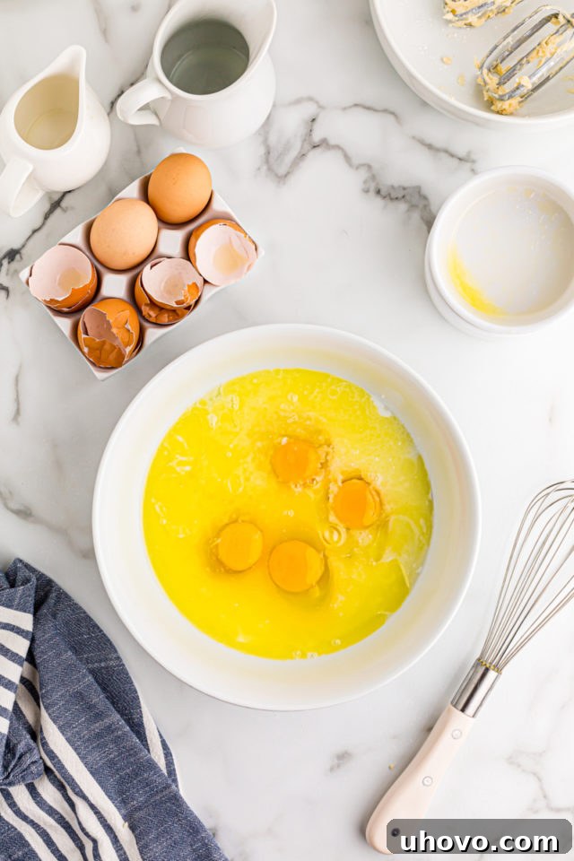 All the lemon chess filling ingredients, including eggs, sugar, buttermilk, and lemon juice, are gathered in a white mixing bowl before whisking.