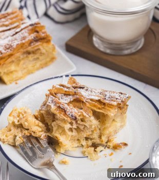 A mouthwatering slice of crinkle cake on a plate with a bite on a fork, ready to be enjoyed.