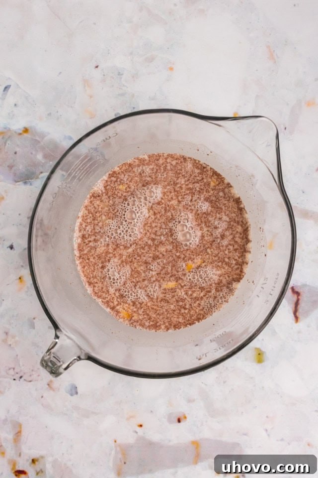 A close-up, overhead view of the custard mixture in a mixing bowl, showcasing its smooth, creamy consistency after whisking.