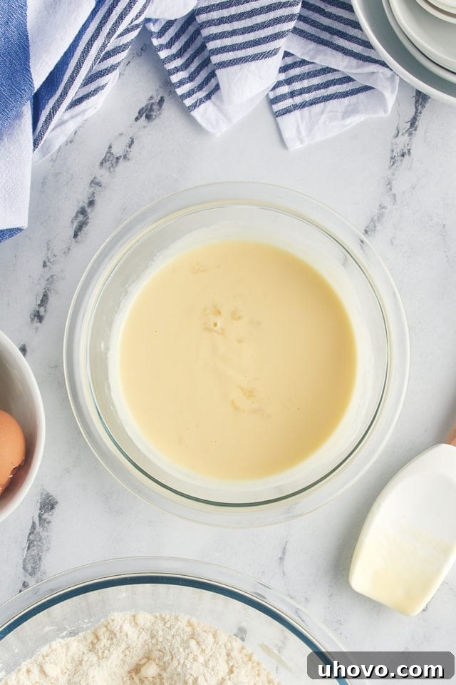 The combined wet and dry ingredients gently mixed until just incorporated, forming a thick, uniform cake batter in the mixing bowl.