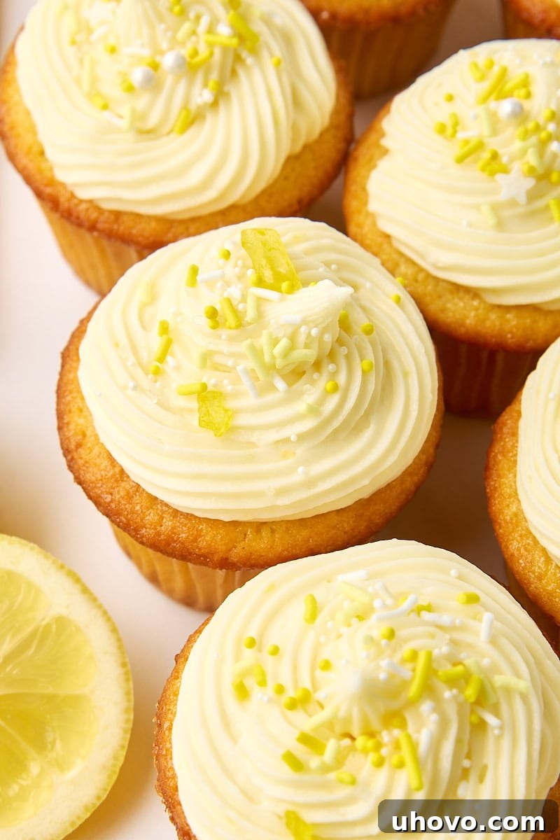 Several vibrant lemon cupcakes adorned with yellow and white sprinkles, presented on a bright white background, radiating a cheerful and celebratory feel.