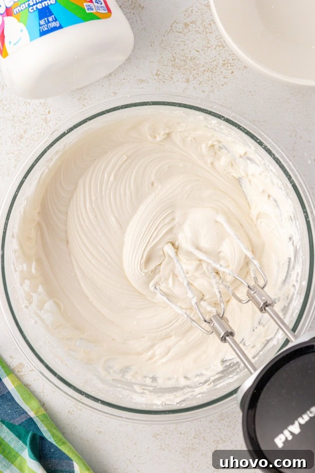 overhead view of marshmallow frosting in a glass mixing bowl